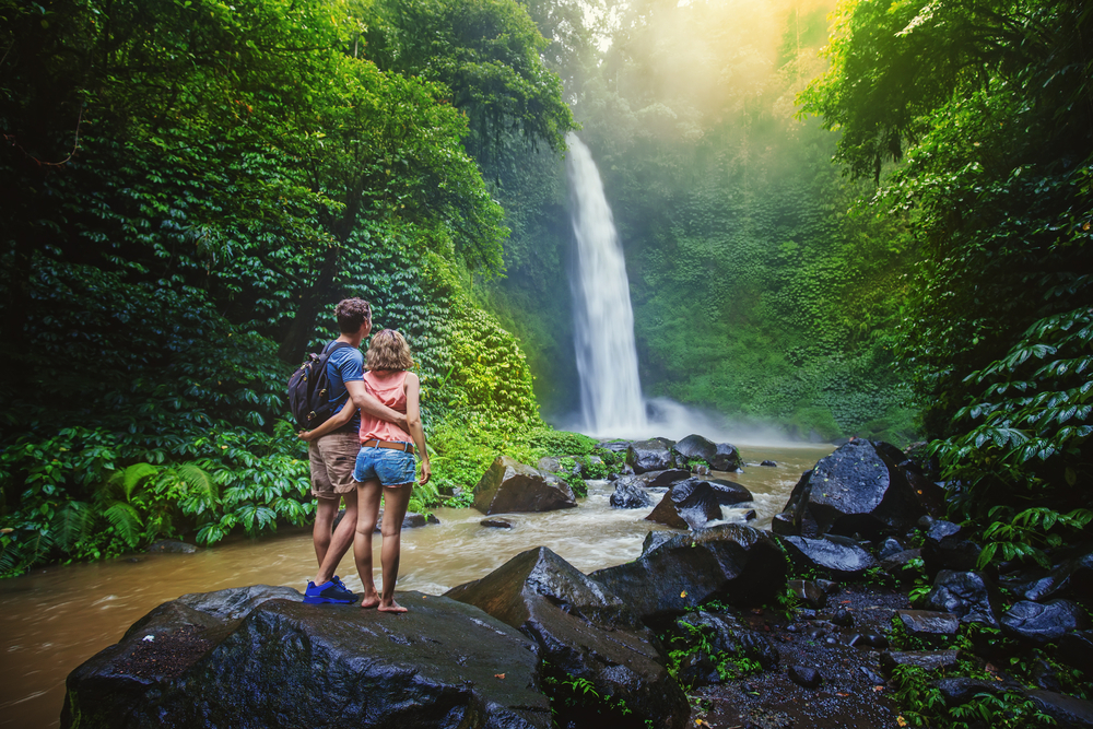 Couple,looking,at,the,gorgeous,waterfall